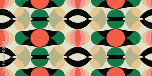 A geometric pattern with circles and elongated shapes in green black and orange on a cream background