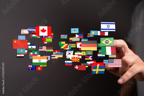 Concept of global community and internationalism represented by a hand holding flags of different nations. Symbolizes peace, unity, and world co