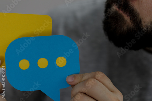 Man with a beard holds blue...