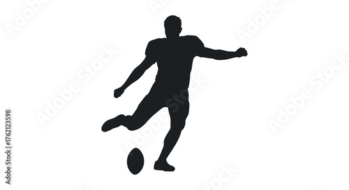 Dynamic silhouette of a male athlete in motion kicking a rugby ball during a game silhouette