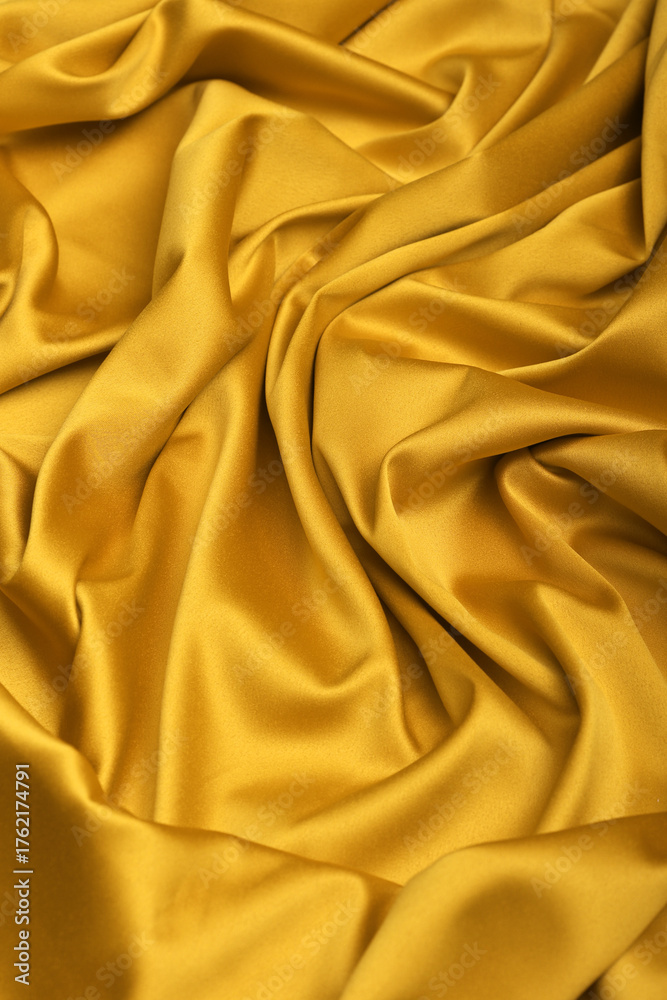 Fototapeta premium Close-up of luxurious yellow acetate satin fabric, heavily draped and folded to showcase its silky texture, rich luster, and flowing nature, ideal for fashion and elegant apparel design.