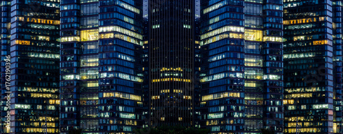 Multi-stories office building at night with worker working overtime. late night at office. lighting and working people within