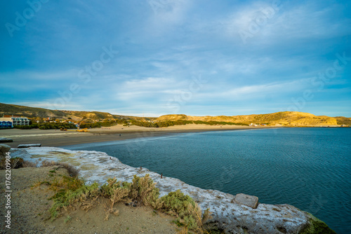 Wallpaper Mural A beach with a rocky shoreline and a body of water Torontodigital.ca