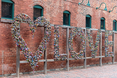 old brick wall with love locks at distillery district
