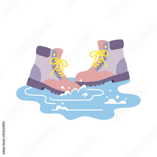 Colorful boots stepping in water puddle during winter season  