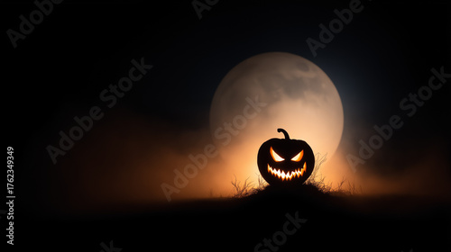 Sinister jack o lantern silhouette glowing in mist under full moon