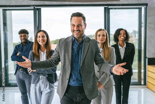 Diverse business team welcoming new members to office