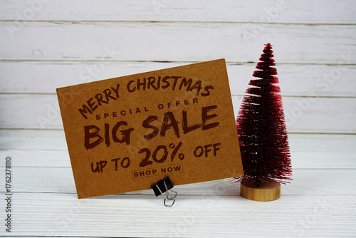 Festive display with small decorative Christmas trees with "Special Offer Merry Christmas Big Sale up to 20% off, Promotion Holiday Sale Event