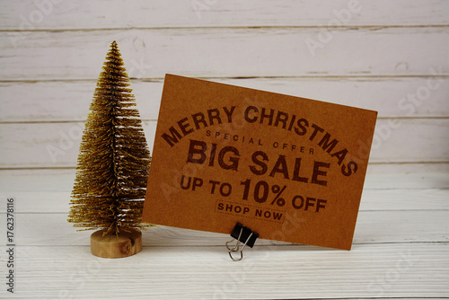 Festive display with small decorative Christmas trees with "Special Offer Merry Christmas Big Sale up to 10% off, Promotion Holiday Sale Event