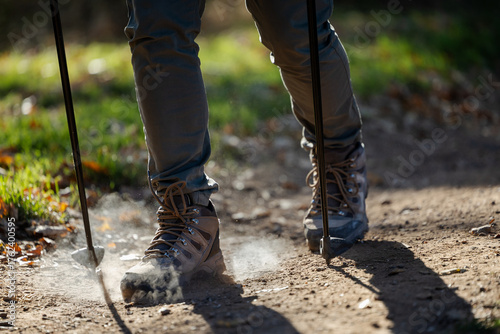 Hiking with trekking poles on a dusty trail