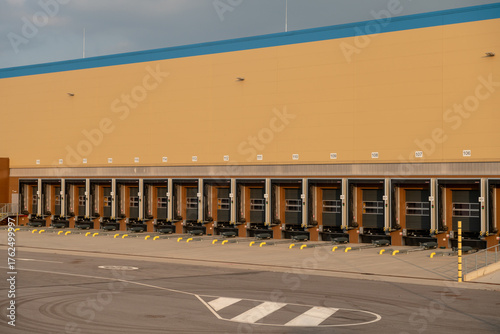 A modern logistics hub for goods and packages ready for shipment, an automated warehouse with truck loading and unloading areas for e-commerce and product distribution. Freight and product transport.