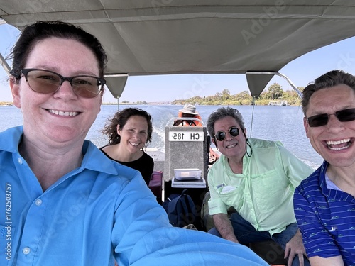 Joyful friends exploring nature by boat