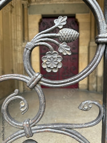 Intricate metal gate featuring floral and pine motifs