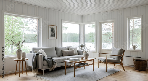 Fototapeta Naklejka Na Ścianę i Meble -  Scandinavian living room, bright, minimalist. Natural daylight, comfortable furniture, lake views through large windows. Tranquil, modern home atmosphere