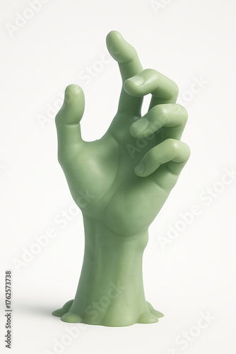 Green zombie hand sculpture on white background