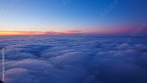 Above the Clouds: The sky transforms into a stunning tapestry of hues, showcasing the sublime artistry of nature, with billowing clouds and the fading glow of a distant sunrise.