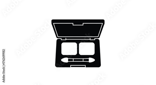 Open makeup palette with eyeshadow and applicator a stark silhouette