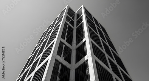 Soaring architectural marvel presenting a powerful interplay of geometric lines and stark contrasts, capturing the essence of urban modernism under a vast sky