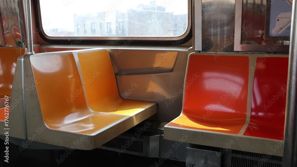 custom made wallpaper toronto digitalempty seats and looking out the window of moving elevated subway train in new york city nyc brooklyn metro commute pov move ride riding nobody yellow orange red seats d line passing buildings
