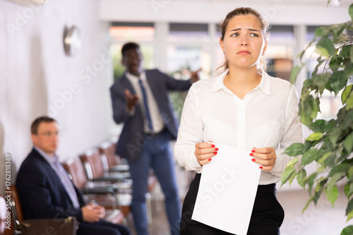 Vászonkép Angry hot-tempered boss shouts yells at hired employee girl in office reception