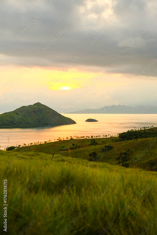 Obraz premium Scenic Island View at Sunset with Lush Green Grass.