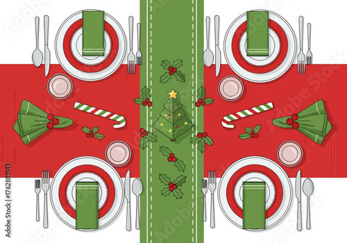 Festive table setting with plates cutlery napkins candy canes holly and a green runner with a Christmas tree design