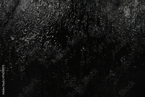 Black background, created by water flowing from the top, black wall as a waterfall.