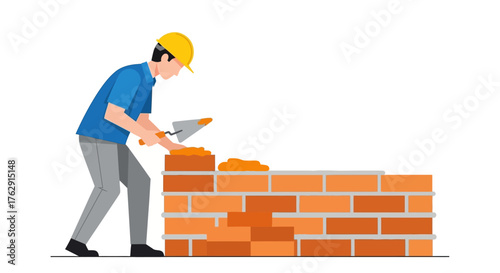 A construction worker with a yellow helmet is building a brick wall using a trowel to apply mortar