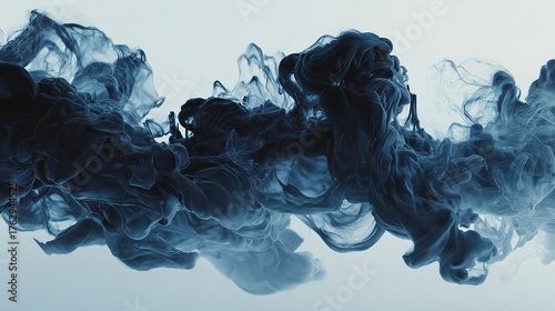 Abstract dark blue ink cloud swirling in water against a gradient background.