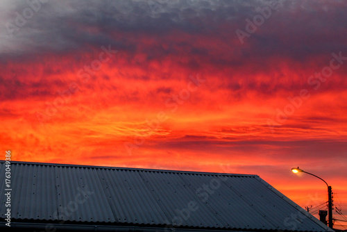 Dramatic sunset over roof