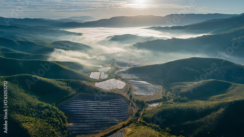 Aerial view of solar panels in misty mountain valley, symbolizing renewable energy and sustainable technology