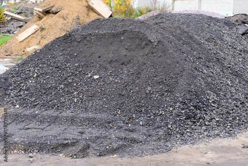 фотографія Pile of asphalt millings for road construction work