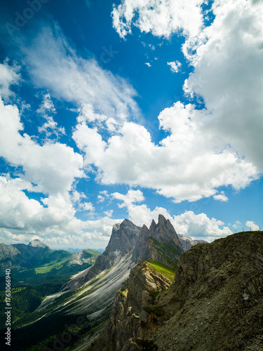 Spectacular view of Seceda ridgeline in the Dolomites, Italy. Dramatic limestone peaks rising above vibrant green slopes under a bright summer sky — a breathtaking natural masterpiece.