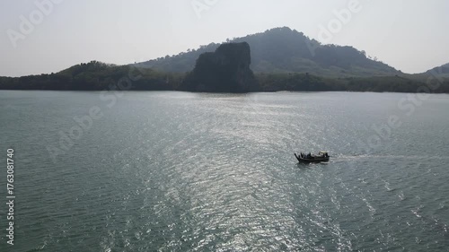 Longtail boat speeding on the sea at Koh Libong, one of tropical islands in Andaman sea in Trang province, Thailand.