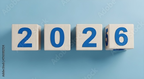 Four wooden blocks arranged in a row on a light blue background, displaying the numbers 2, 0, 2, 6, representing the year 2026 and future planning