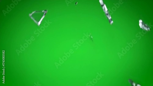 Dynamic explosion of a glass pane shattering outwards on green screen background high speed, vfx, production