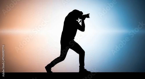 Silhouette of a Photographer Capturing a Moment with a Camera in Hand Against a Colorful Background