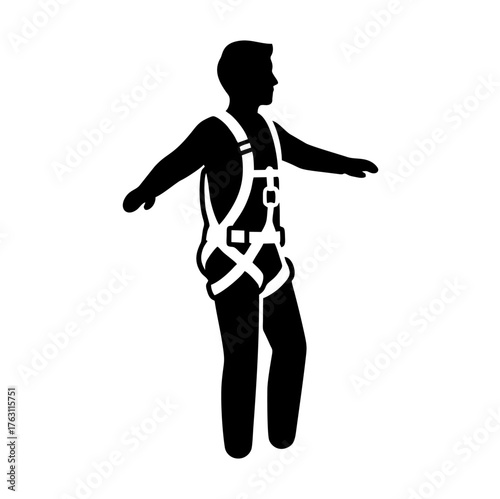 Silhouette of a person wearing a safety harness with arms outstretched.