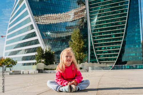 Photography Child girl in front of the skyscrapers of Moscow City in summer.