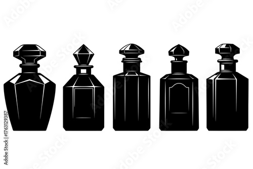 Collection of five antique black glass liquor decanters with ornate stoppers displayed in a row against a white background