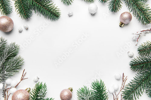 Christmas frame with pine branches and ornaments on white background