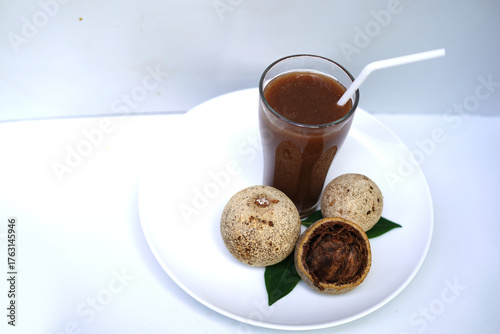 Organic Woodapple Juice in Glass with White Plate.