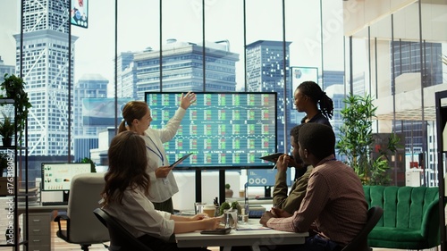 Management team holding a strategy session with the staff, focusing on digital marketing trends, budget allocation and progress tracking to achieve goals and boost market presence. Camera B.