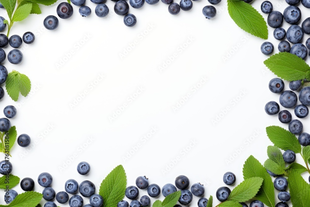 Fototapeta premium Fresh blueberries and green leaves arranged in a frame on a white background, creating a vibrant and healthy image