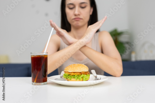 women rejecting fast food and soda with crossed arms gesture, promoting healthy eating habits, dietary choices or lifestyle change concepts for health related content.
