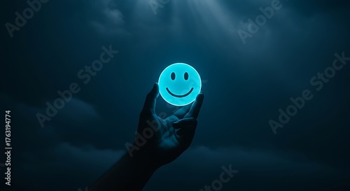 Hand holding glowing smiley face orb in dark, cloudy sky creating ethereal and hopeful atmosphere with a symbol of positivity and light, representing hope and optimism.