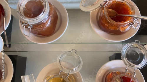 Criossants, jam, and cakes in a restaurant. Typical breakfast.