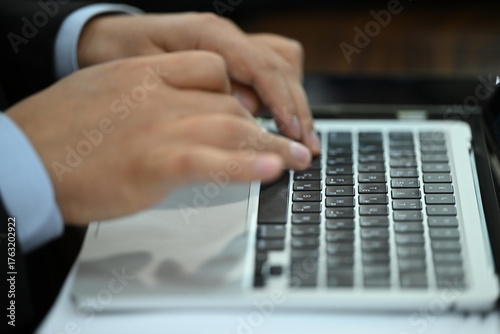 businessman typing on a laptop