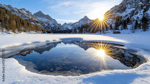 Fototapeta Naklejka Na Ścianę i Meble -  Serene winter landscape featuring frozen lake surrounded by snow covered mountains