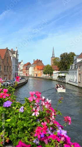 Beautiful travel footage. Colorful flowers in city, people riding on river in boat. Vertical footage.
